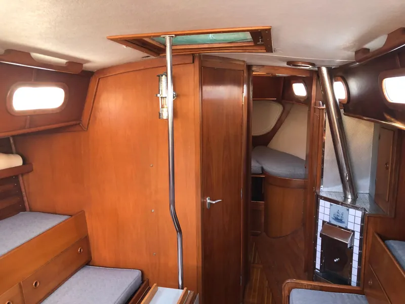 Slide: The Image of Interior of 1968 LeComte Northeast 38 sailboat with wooden furnishings and cozy seating. - 26