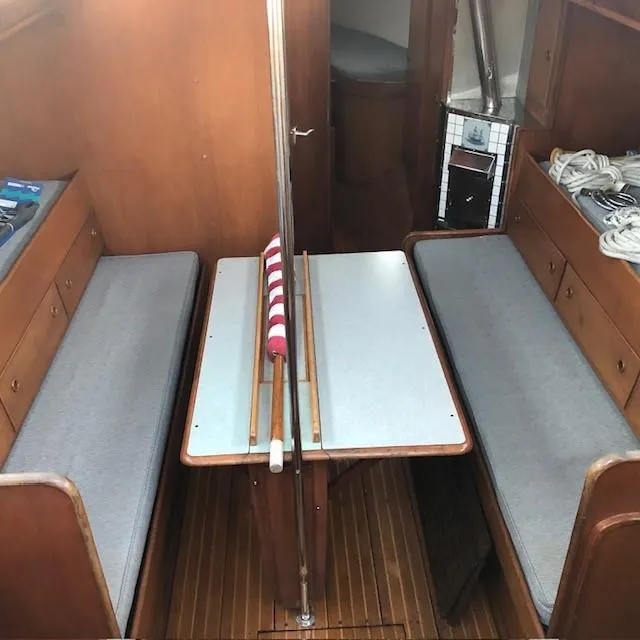 Slide: The Image of Interior of 1968 LeComte Northeast 38 sailboat with wooden benches and table. - 28
