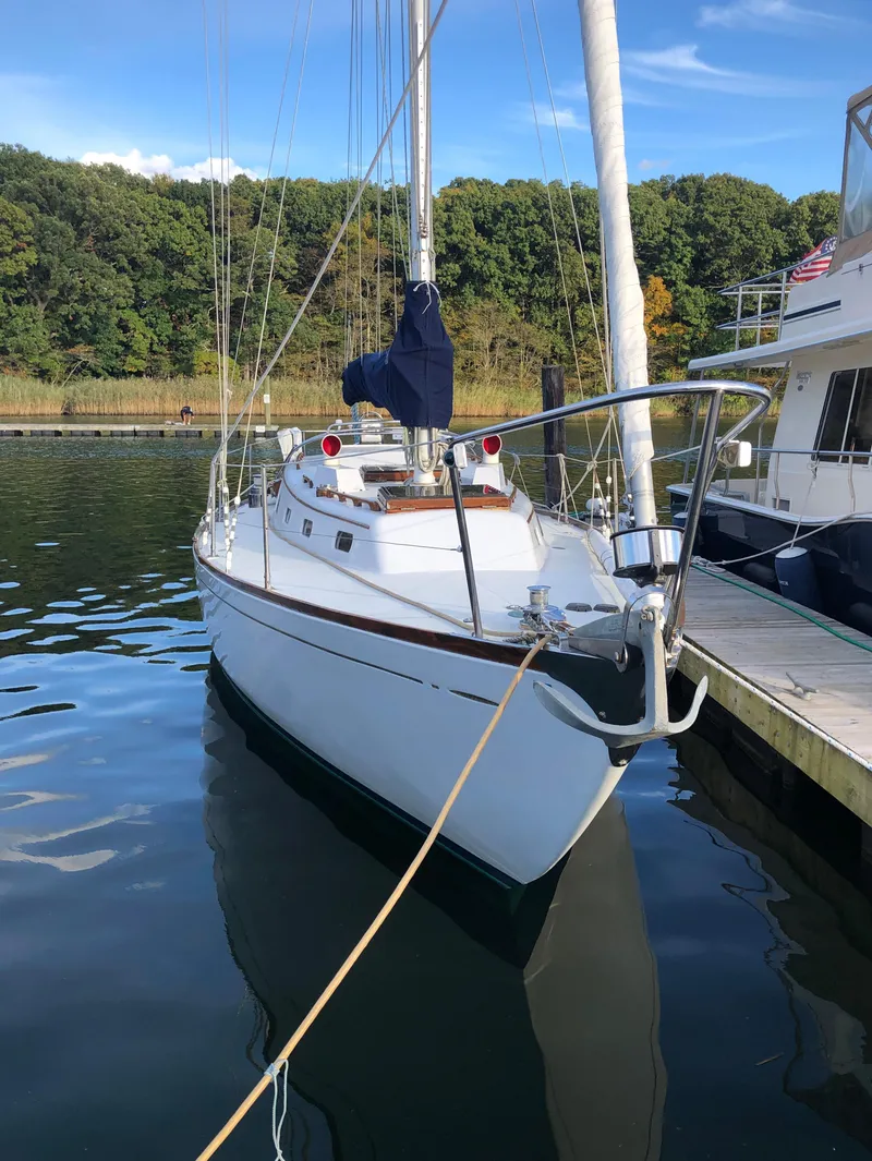 Slide: The Image of 1968 LeComte Northeast 38 sailboat docked in a serene marina setting. - 3