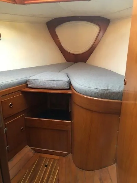 Slide: The Image of 1968 LeComte Northeast 38 cabin interior with wooden cabinetry and cushioned berth. - 30