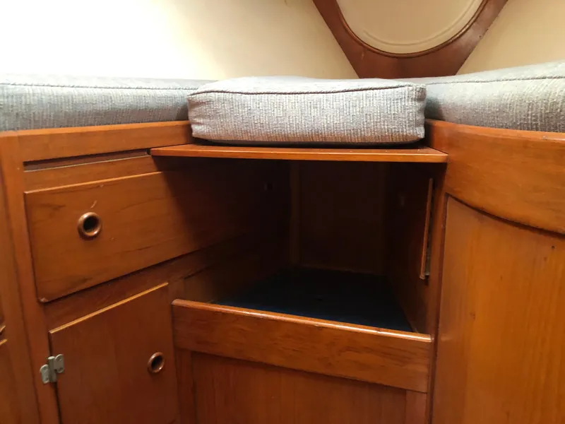 Slide: The Image of Wooden interior storage of 1968 LeComte Northeast 38 sailboat with cushion and drawers. - 33