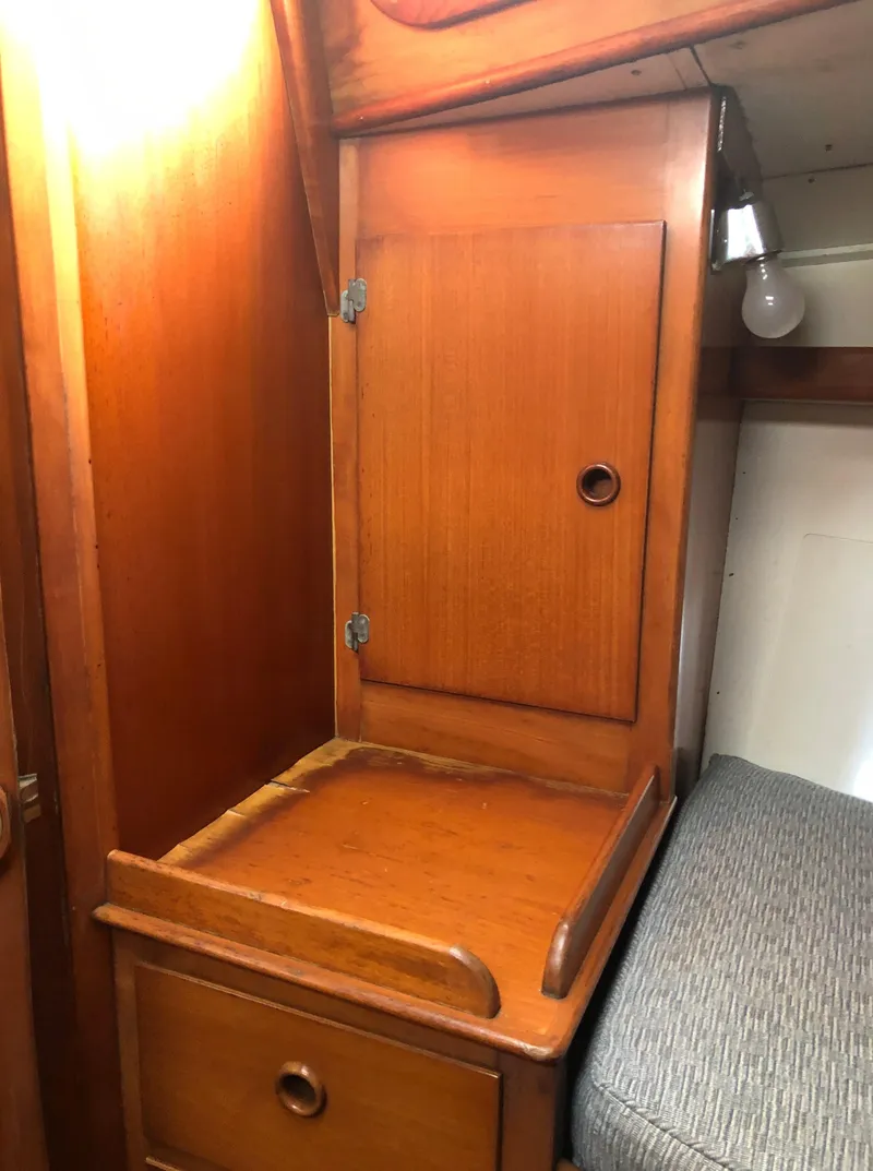 Slide: The Image of Wooden cabinet interior of 1968 LeComte Northeast 38 sailboat with storage and seating. - 34