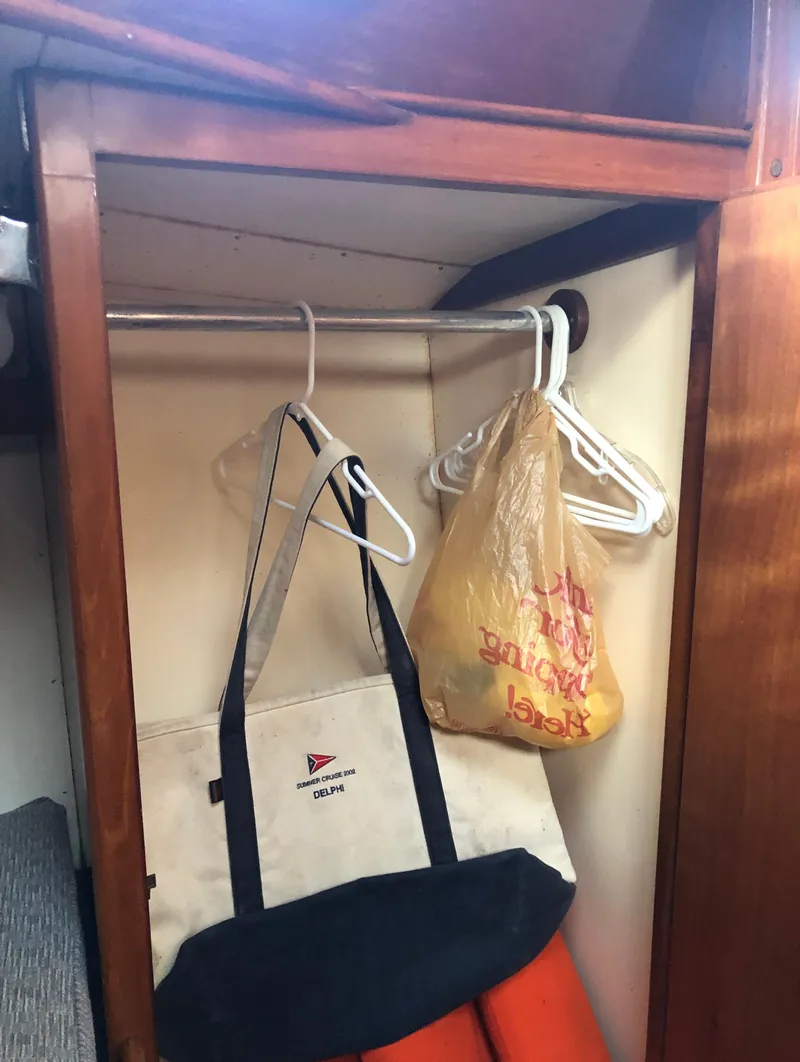 Slide: The Image of Closet in 1968 LeComte Northeast 38 sailboat with hangers and bags. - 35