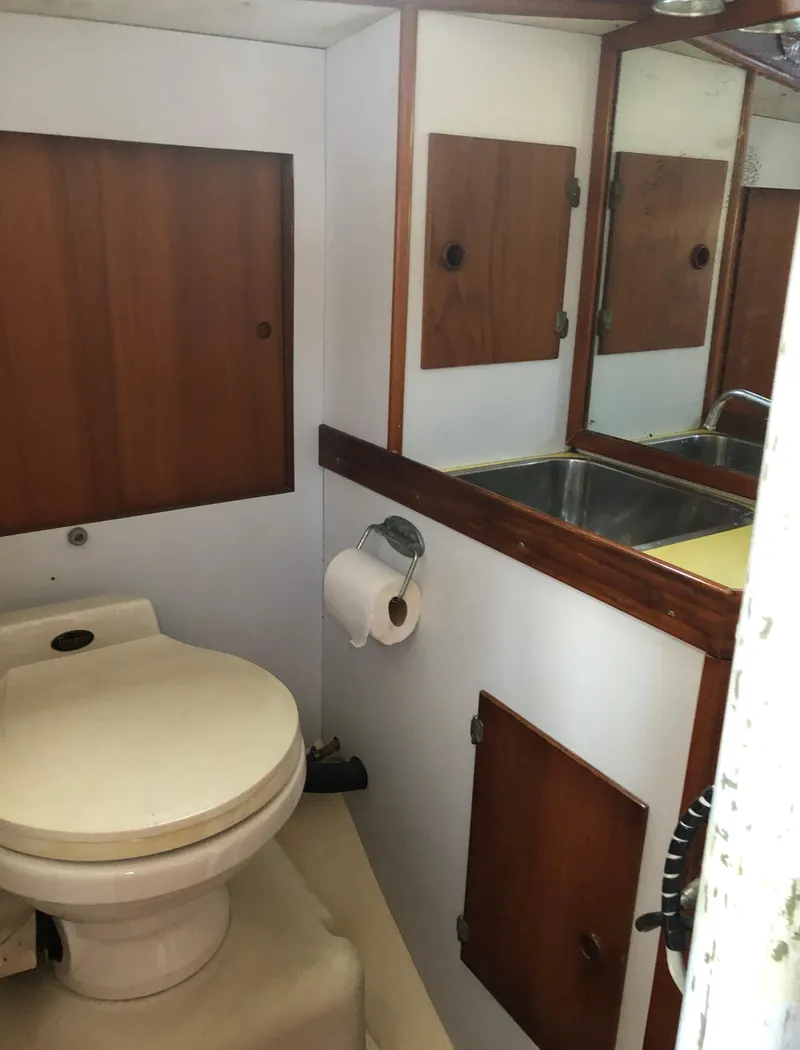 Slide: The Image of 1968 LeComte Northeast 38 yacht bathroom with wooden cabinets and a compact sink. - 36