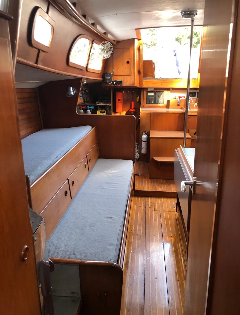 Slide: The Image of 1968 LeComte Northeast 38 yacht interior with wooden furnishings and cozy seating area. - 38