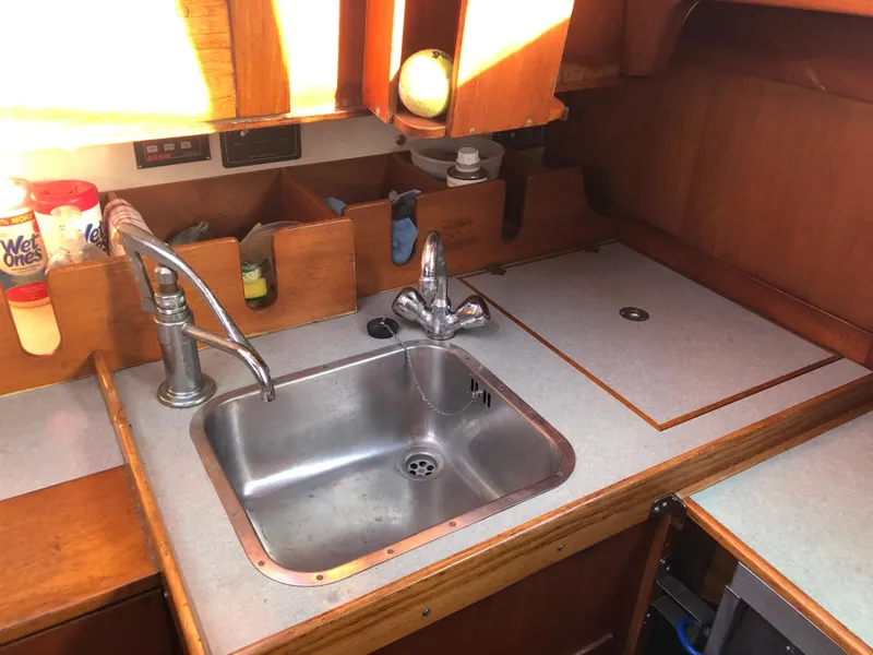 Slide: The Image of 1968 LeComte Northeast 38 yacht kitchen with stainless steel sink and wooden cabinetry. - 41