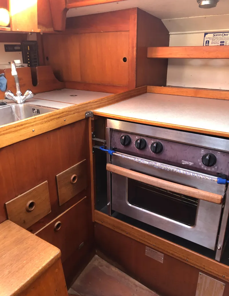 Slide: The Image of 1968 LeComte Northeast 38 yacht kitchen with wooden cabinetry and stainless steel oven. - 42