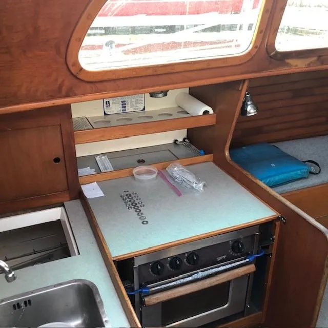 Slide: The Image of Interior of 1968 LeComte Northeast 38 sailboat kitchen with stove and sink. - 43
