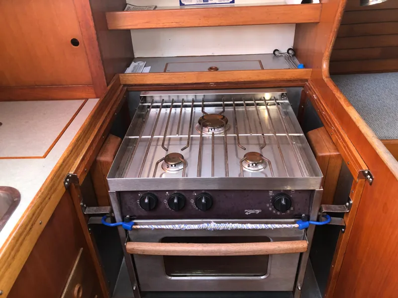 Slide: The Image of 1968 LeComte Northeast 38 yacht kitchen with stainless steel stove and wooden cabinetry. - 44
