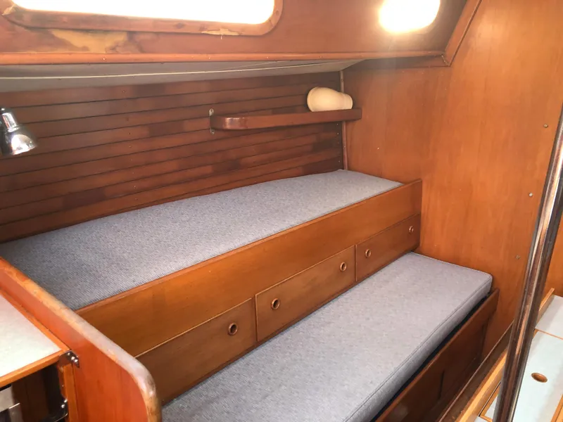 Slide: The Image of 1968 LeComte Northeast 38 cabin interior with wooden paneling and blue cushioned seating. - 45