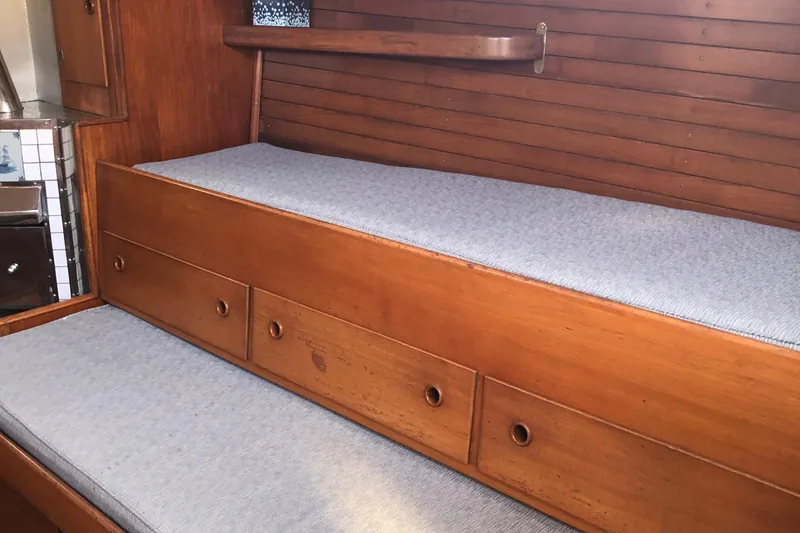 Slide: The Image of Interior of 1968 LeComte Northeast 38 sailboat with wooden bunk and storage drawers. - 47