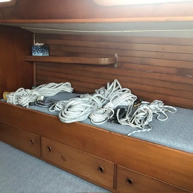 Slide: The Image of Interior of 1968 LeComte Northeast 38 sailboat with ropes on wooden shelf. - 48