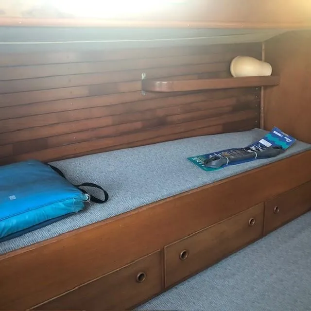 Slide: The Image of Interior of 1968 LeComte Northeast 38 sailboat with wooden paneling and cushioned bench. - 49