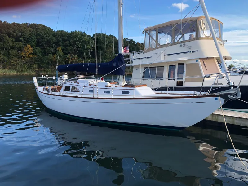 Slide: The Image of 1968 LeComte Northeast 38 sailboat docked beside a larger vessel. - 6