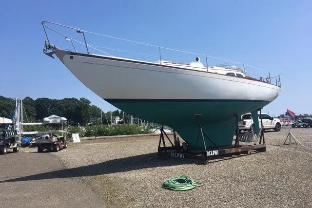 Slide: The Image of 1968 LeComte Northeast 38 sailboat on display at a marina, clear sky background. - 69