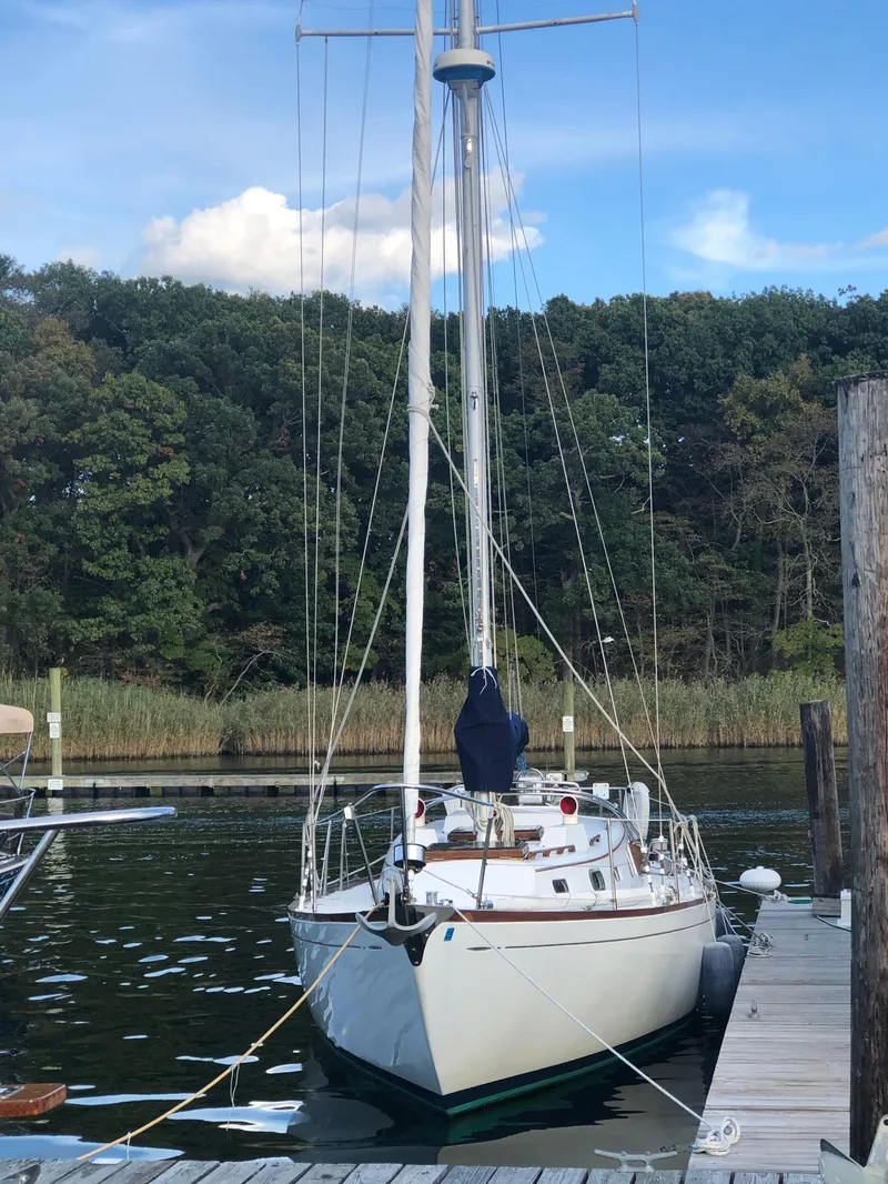 Slide: The Image of 1968 LeComte Northeast 38 sailboat docked by a wooded shoreline. - 7