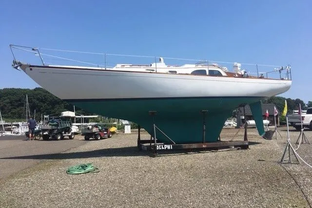 Slide: The Image of 1968 LeComte Northeast 38 sailboat on display in a boatyard under clear blue skies. - 70