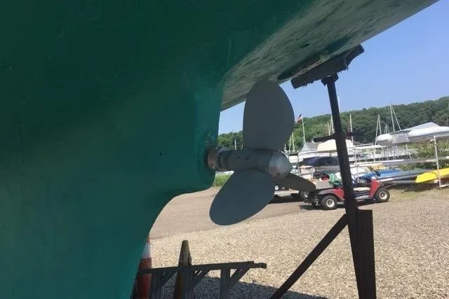 Slide: The Image of Propeller of 1968 LeComte Northeast 38 sailboat in dry dock, with marina background. - 71