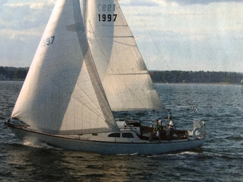 Slide: The Image of 1968 LeComte Northeast 38 sailboat gliding on open water under clear skies. - 8