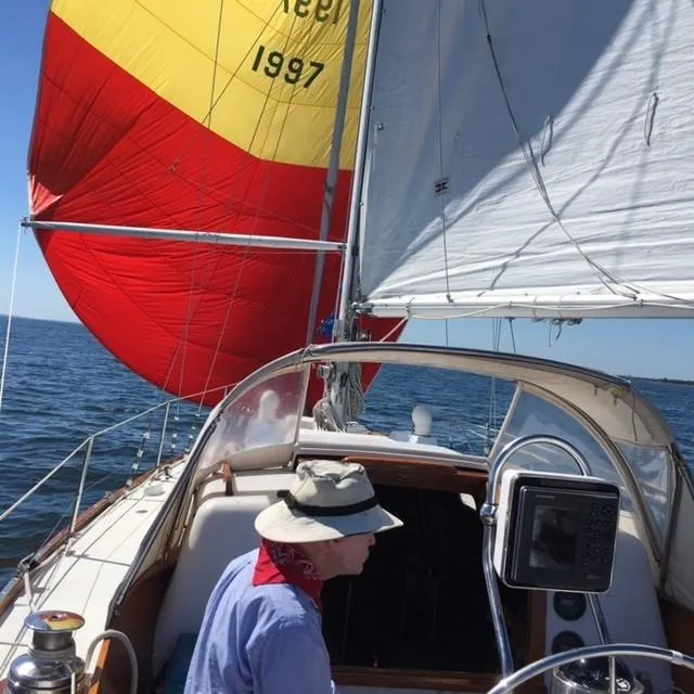 Slide: The Image of Sailing on a 1968 LeComte Northeast 38 with vibrant red and yellow sails. - 9