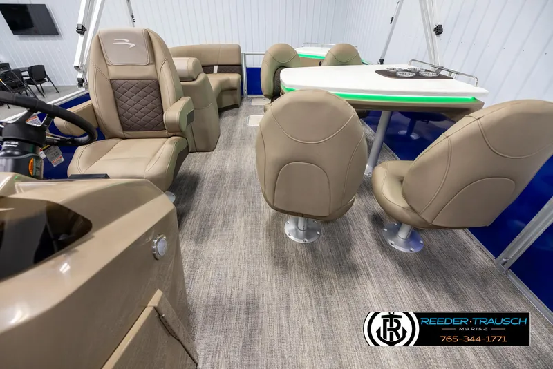 Slide: The Image of Interior of 2025 Bennington 23 SXPDSE pontoon boat with beige seating and table. - 14