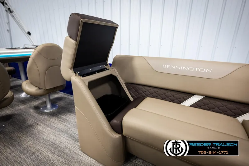 Slide: The Image of 2025 Bennington 23 SXPDSE boat interior with open storage compartment and seating. - 22