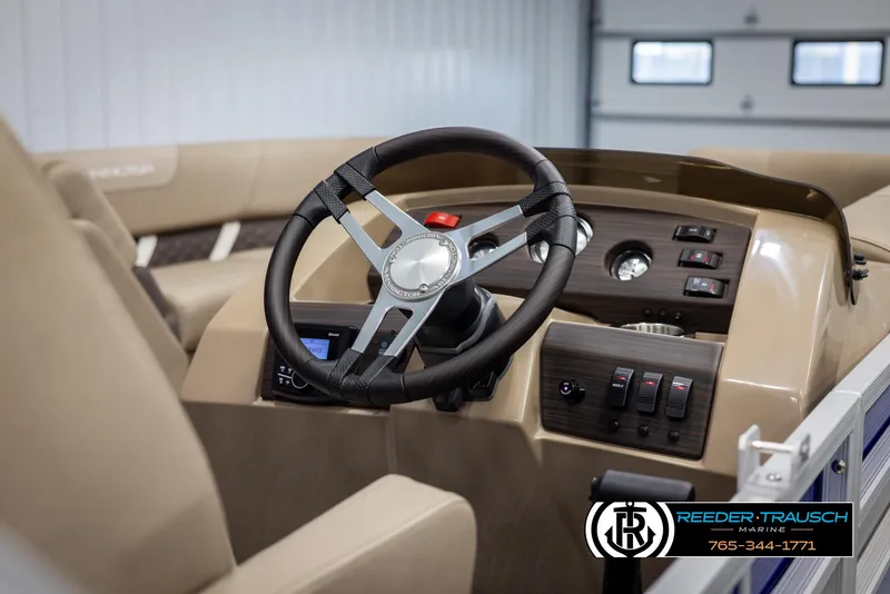 Slide: The Image of 2025 Bennington 23 SXPDSE boat dashboard with steering wheel and control panel. - 25