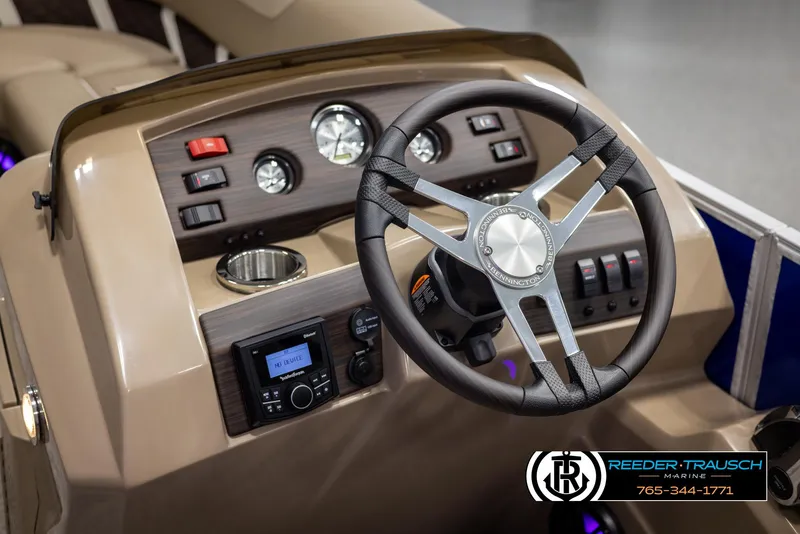 Slide: The Image of Steering console of 2025 Bennington 23 SXPDSE pontoon boat with modern controls and gauges. - 26