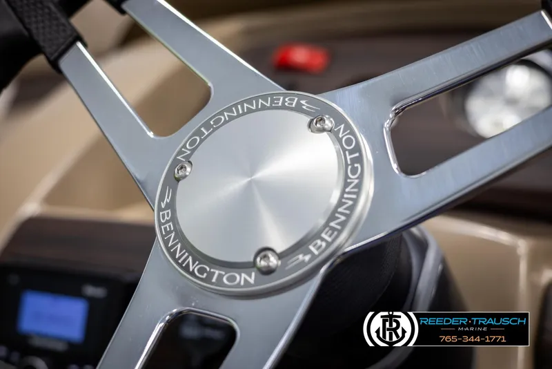 Slide: The Image of Close-up of 2025 Bennington 23 SXPDSE steering wheel with logo detail. - 27