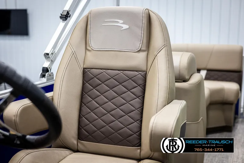 Slide: The Image of Luxurious seating on 2025 Bennington 23 SXPDSE boat, featuring quilted upholstery and armrests. - 33