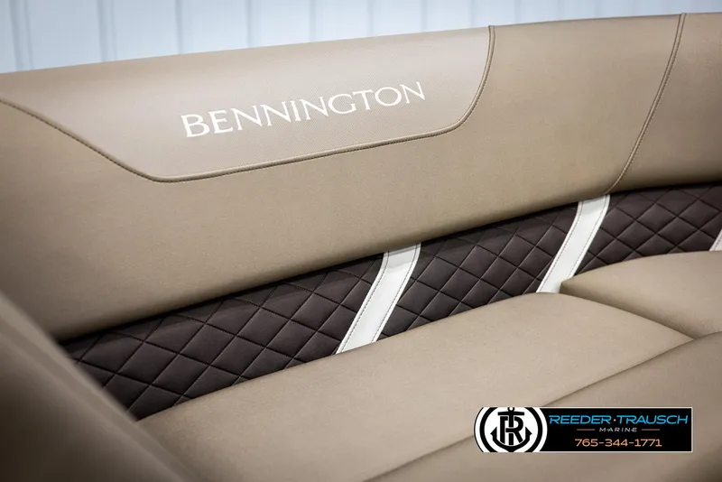 Slide: The Image of 2025 Bennington 23 SXPDSE boat interior with beige and black quilted seating. - 34