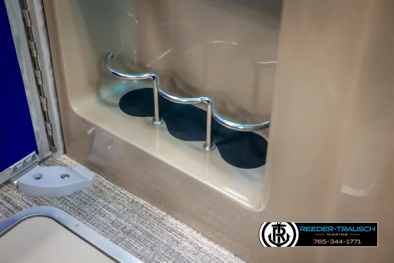 Slide: The Image of Interior detail of 2025 Bennington 23 SXPDSE boat with cup holders and carpeted flooring. - 38