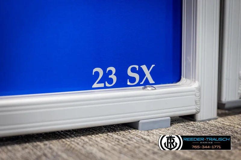 Slide: The Image of 2025 Bennington 23 SXPDSE boat detail with Reeder-Trausch Marine logo. - 44