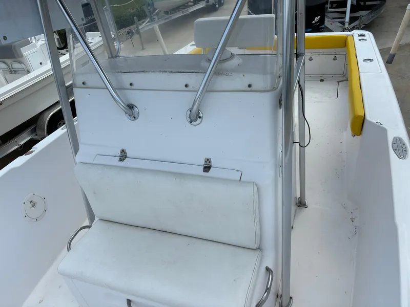Slide: The Image of 2001 Donzi 26 ZF boat interior with white seating and yellow accents. - 10