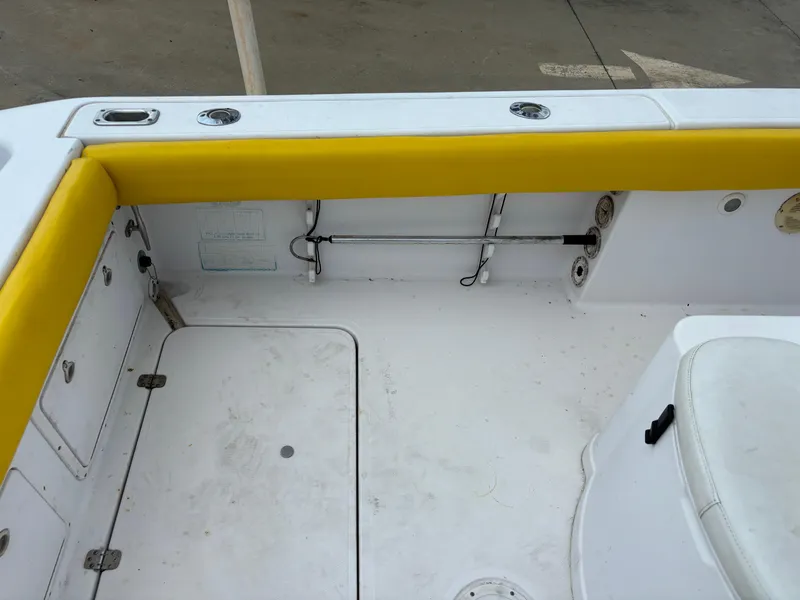 Slide: The Image of 2001 Donzi 26 ZF boat interior with yellow trim and storage compartments. - 11