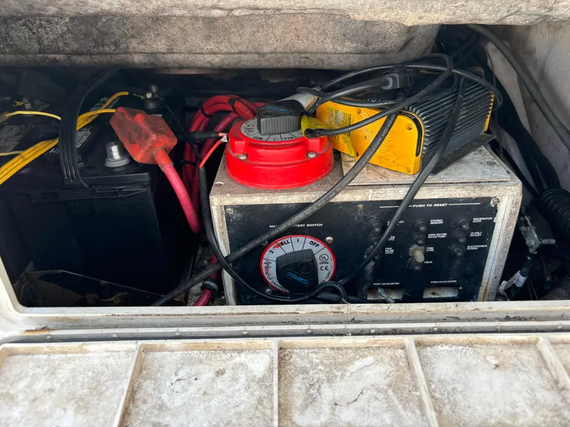 Slide: The Image of 2001 Donzi 26 ZF boat battery compartment with wiring and control panel. - 12