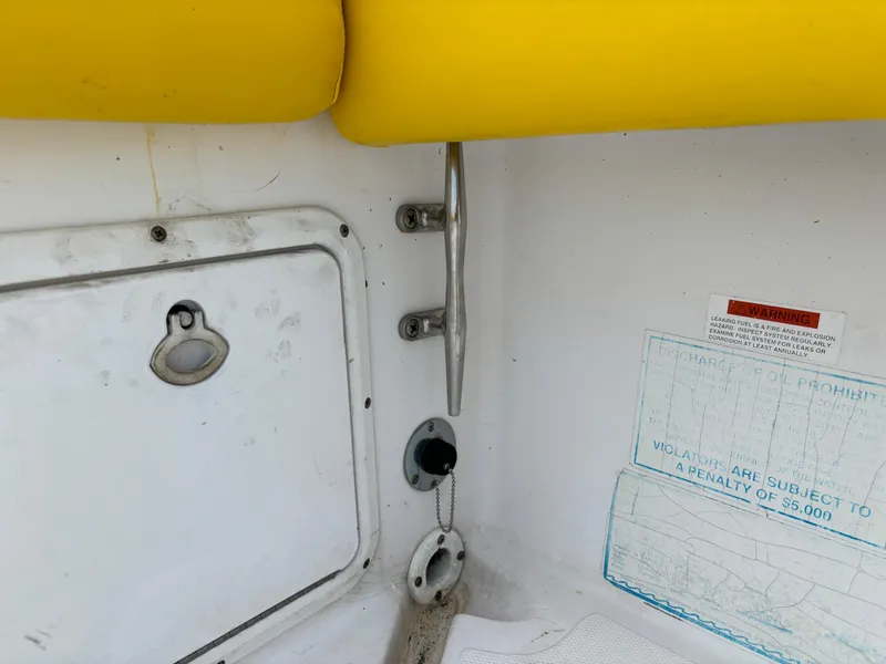Slide: The Image of 2001 Donzi 26 ZF boat interior with yellow cushion and storage compartment. - 14