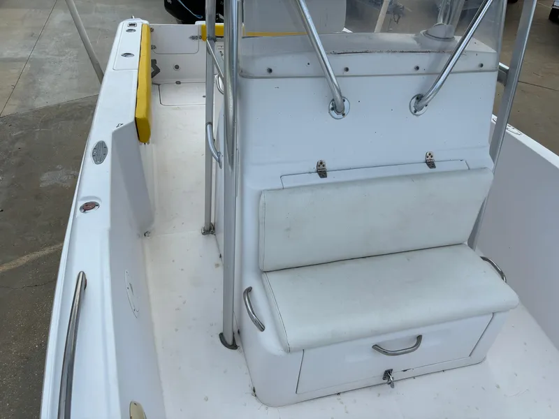 Slide: The Image of 2001 Donzi 26 ZF boat interior with white seating and storage. - 15