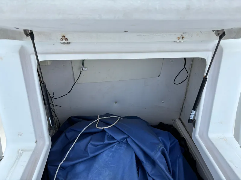 Slide: The Image of Storage compartment of a 2001 Donzi 26 ZF boat with blue cover inside. - 17