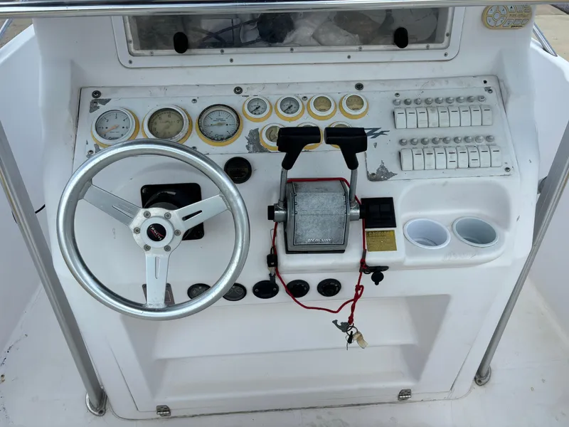 Slide: The Image of Dashboard of a 2001 Donzi 26 ZF boat with steering wheel and controls. - 3