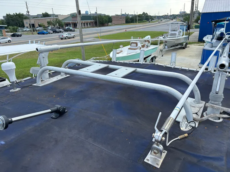 Slide: The Image of 2001 Donzi 26 ZF boat deck with railings and equipment, parked near a road. - 6