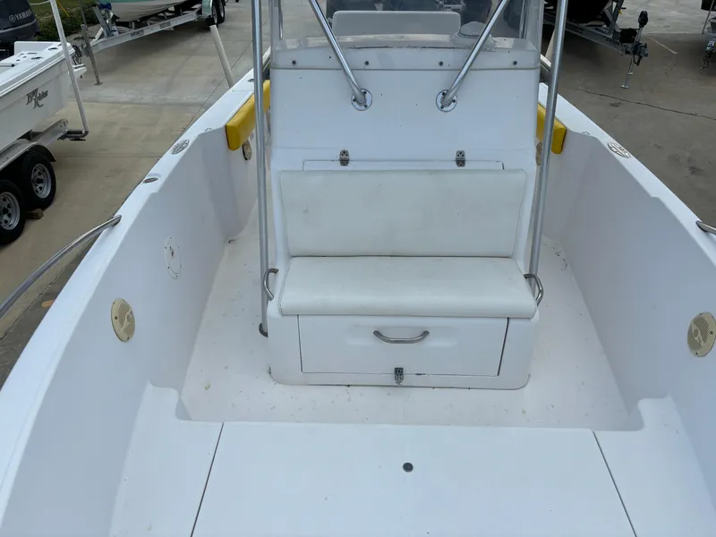 Slide: The Image of 2001 Donzi 26 ZF boat interior with white seating and storage compartment. - 8