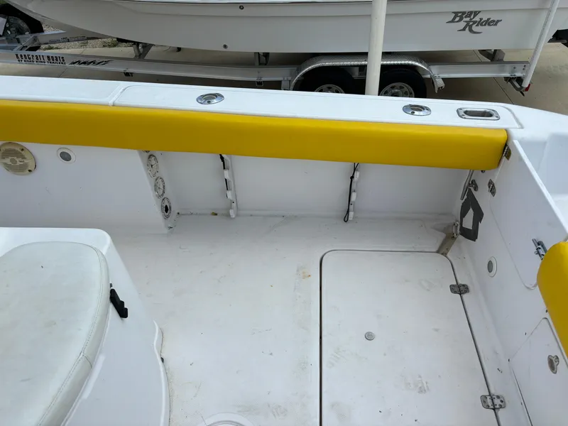 Slide: The Image of 2001 Donzi 26 ZF boat interior with yellow trim and white seating. - 9