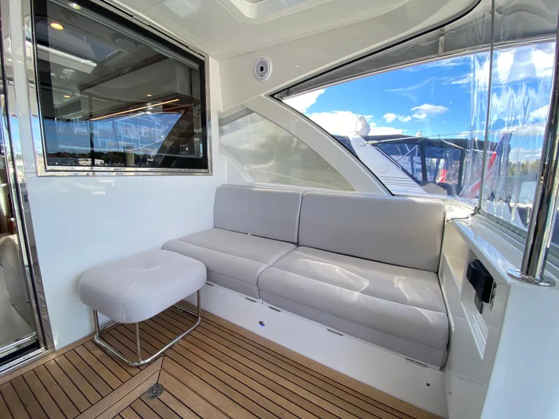 Slide: The Image of Luxurious interior of 2025 Riviera 465 SUV yacht with plush seating and wooden flooring. - 11