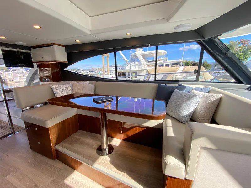 Slide: The Image of Luxurious interior of 2025 Riviera 465 SUV yacht with elegant seating and panoramic windows. - 15