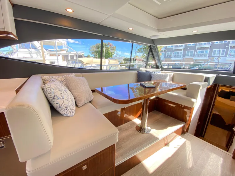 Slide: The Image of Luxurious interior of 2025 Riviera 465 SUV yacht with elegant seating and table. - 18