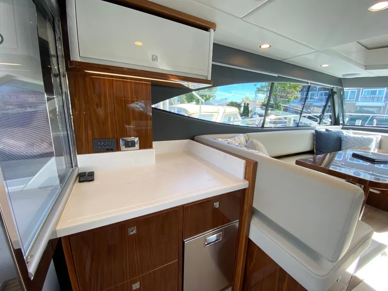 Slide: The Image of Luxurious interior of 2025 Riviera 465 SUV yacht with modern seating and cabinetry. - 19