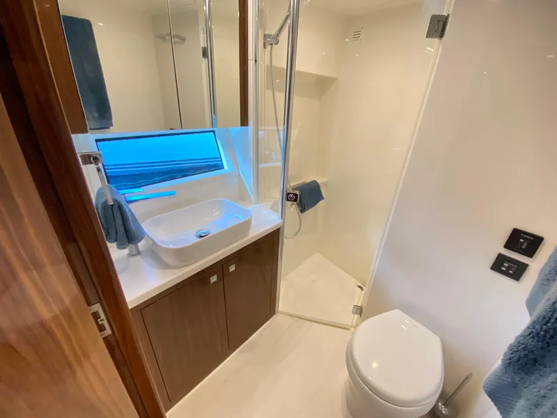 Slide: The Image of Luxurious bathroom in 2025 Riviera 465 SUV yacht with modern fixtures and elegant design. - 27