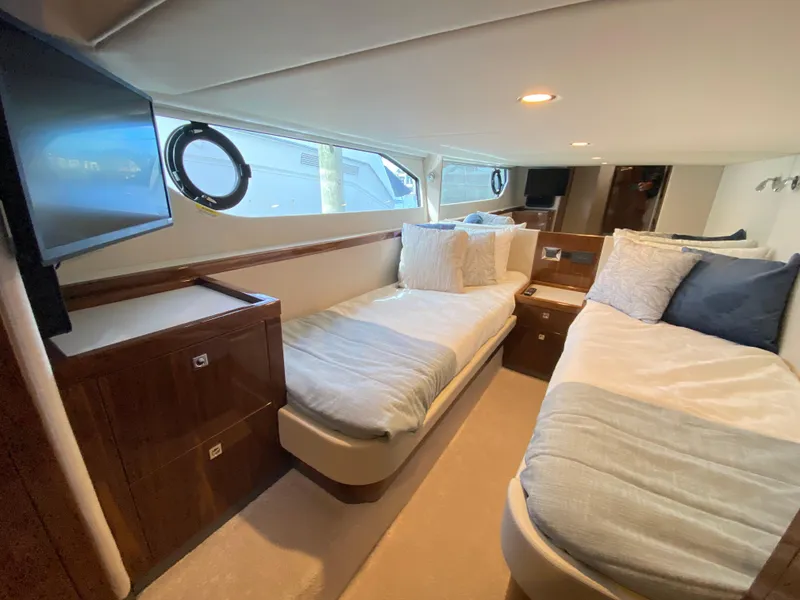 Slide: The Image of Luxurious interior of 2025 Riviera 465 SUV yacht with twin beds and modern amenities. - 29