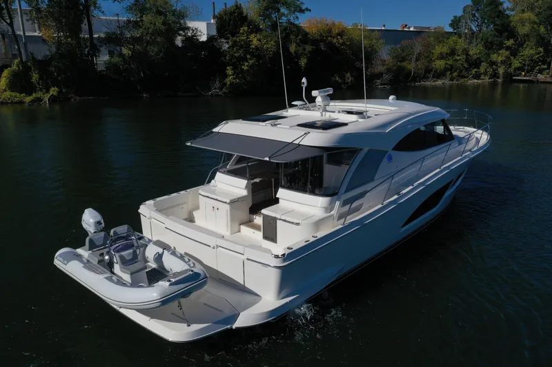 Slide: The Image of 2025 Riviera 465 SUV yacht cruising on a serene river. - 3